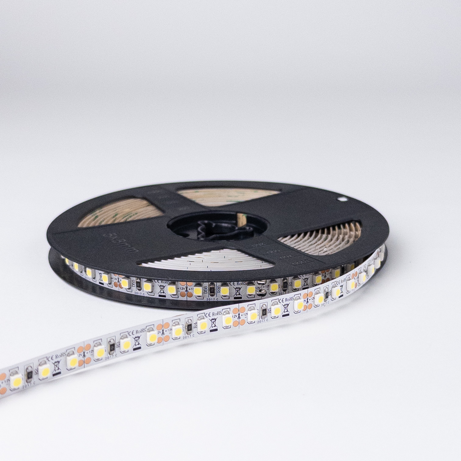 LED traka 3528 6000K namotana na crni kotur, sa oznakama +12V i CE RoHS na beloj ploči