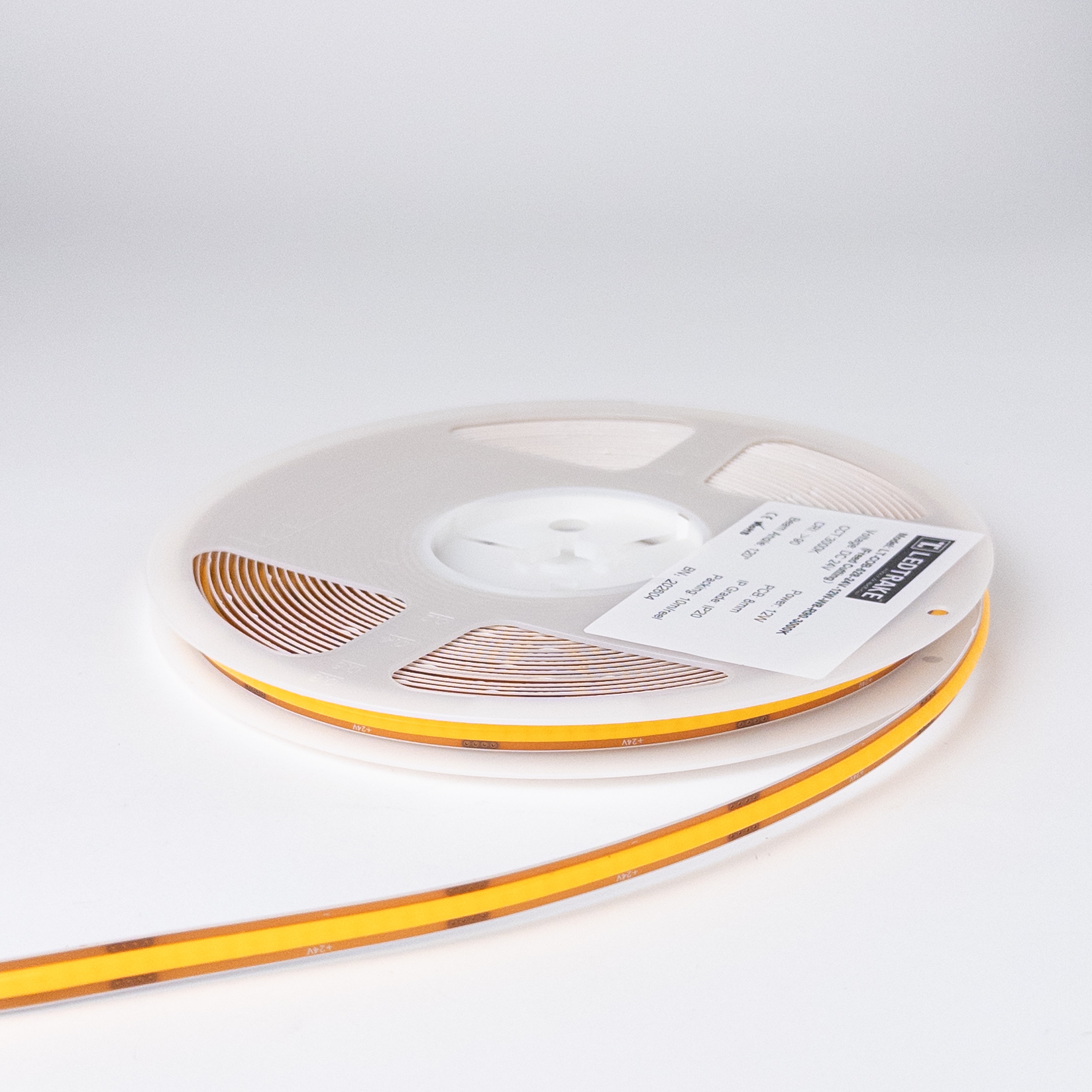 COB LED traka 12W 3000K na koturu od 10 m, sa nalepnicom Freed Cutting i podacima DC 24V, PCB 8mm